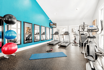 A gym with a blue wall and a red ball.